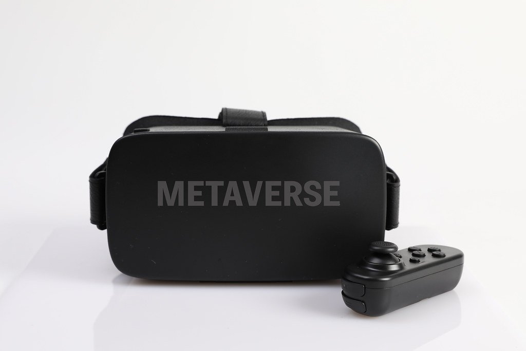 A virtual reality headset and a controller with the word "metaverse" displayed prominently on the front, symbolizing access to a lifestyle alive in a virtual world.